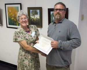 Berkeley Arts Council president Malinda Shaver presents the "Best in Show" certificate to Neil Super.